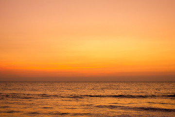 bright yellow gray pink sunset sky over the ocean