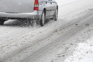 Driving a car in the winter  with snow on the road. Concept of driving in extreme weather conditions