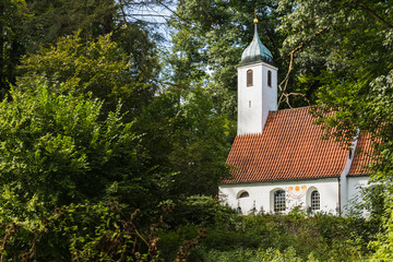 church hidden among the trees of a forest