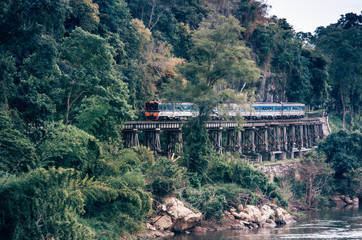 Fototapeta na wymiar Train ride​s on Burma​ railway​(The Death​-Railway)​in Kanchanaburi, Thailand.