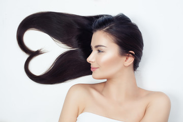 Young beautiful woman with healthy curly hair. Heart of hair, haircare concept