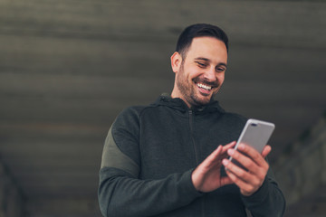 Man in sportswear using phone.