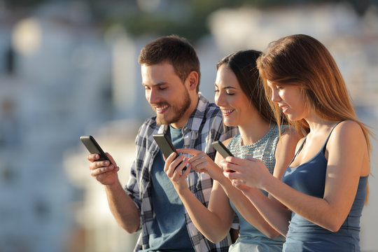 Group Of Friends Using Their Smart Phones