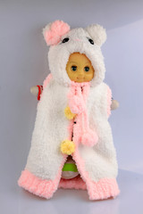 toys doll wearing a sweater