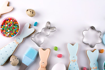 Preparation of gingerbread cookies. Easter cookies in the shape of  a  funny  rabbit , tools necessary to make gingerbread pastry, colored sprinkles. Easter concept.