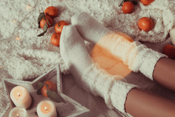 Women's legs in white knitted socks. photo in Hyugge style,