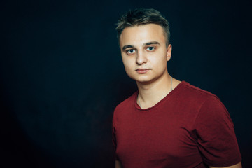 portrait of a young man on a dark background