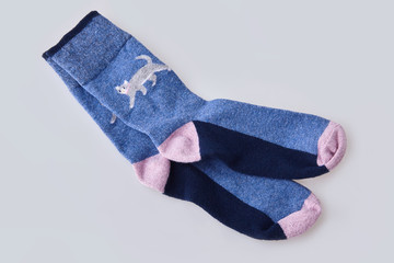 Pair of women's socks isolated on white background. Child's striped socks, white and pink socks