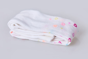 New hearts patterned folded child's tights isolated on white