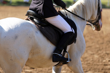 Rider girl at advanced dressage test on equestrian competition