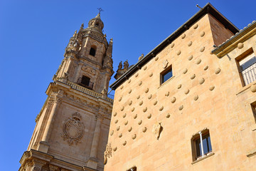 Fototapeta na wymiar Salamanca, Spain - November 15, 2018: Church of the Holy Spirit (Clerecía) and Casa de las Conchas.