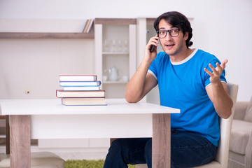 Young handsome student studying at home 