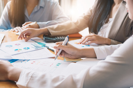 Business People Meeting using laptop computer,calculator,phone,notebook,stock market chart paper for analysis Plans to improve quality next month.