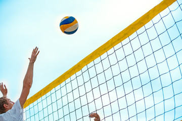 Beach Volleyball. Game ball under sunlight and blue sky.