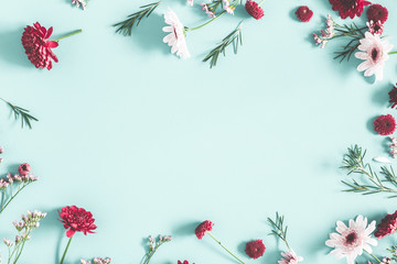 Flowers composition. Eucalyptus leaves and red flowers on pastel blue background. Flat lay, top view