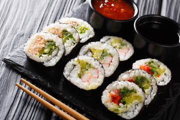 Japanese rolls set close-up served on a slate board. horizontal