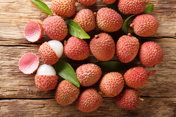 litchi, lichee, lychee, or lichi, Litchi chinensis on old rustic wood background. Horizontal top view