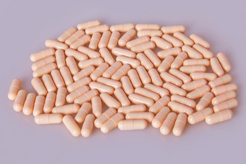 Spilled white capsules on the white background. Vitamin supplements tablets