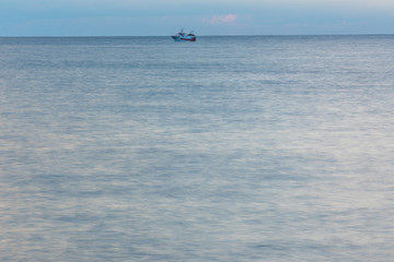 Fototapeta premium Long Exposure of the Mediterranean Sea Coast with Blue Sky in Southern Italy