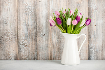 Fresh colorful tulips in a jug
