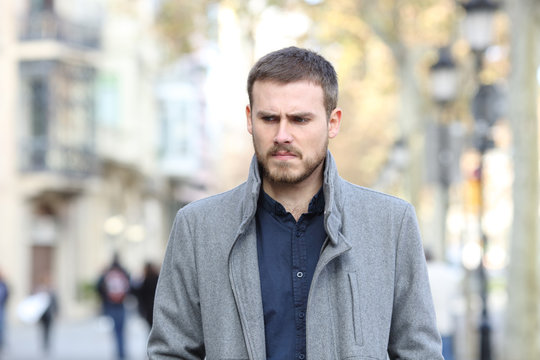 Angry man walking in the street