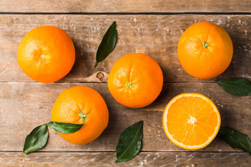 Top view of oranges fruits composition with green leaves and slice