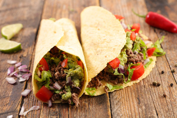 tacos, fajita on wood background