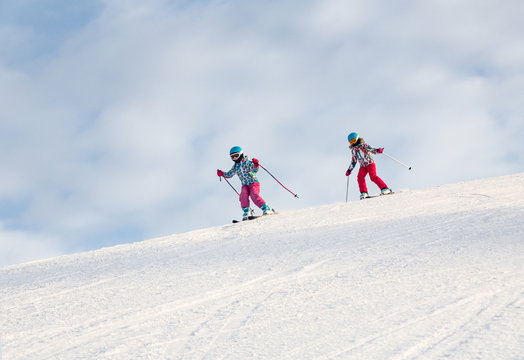 little girls skiing to slope