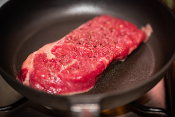 Dry aged rib eye steak on iron cast pan