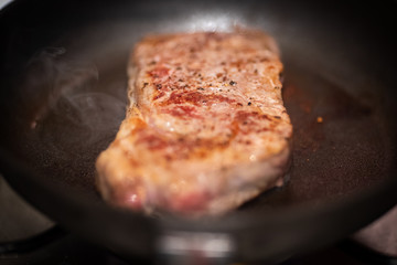 Dry aged rib eye steak on iron cast pan