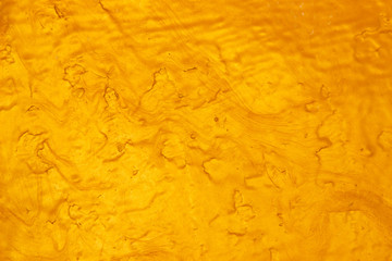 Abstract Gold polished metal brushed background or Shiny yellow leaf gold steel texture. Brushed metal plate with reflected light golden.