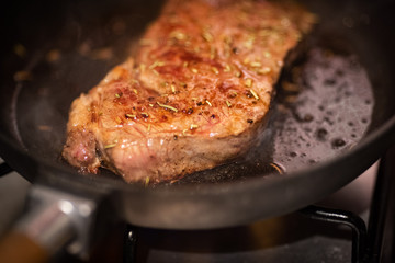 Dry aged rib eye steak on iron cast pan