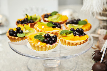 Candy bar. Festive table with deserts,  tartlets, cookies and cakepops.