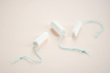 Hygienic tampons on a light background. Three tampons of varying absorbency. Close-up.