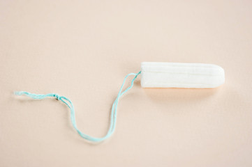 Hygienic tampon on a light background. Close-up.