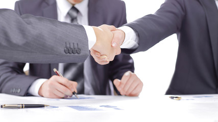 close up.handshake of financial partners after signing the contract