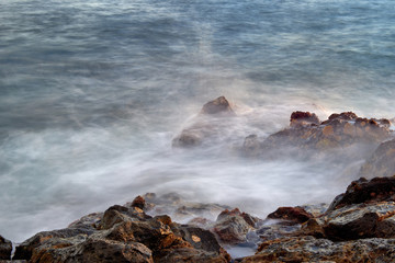 Waves break into shore.
