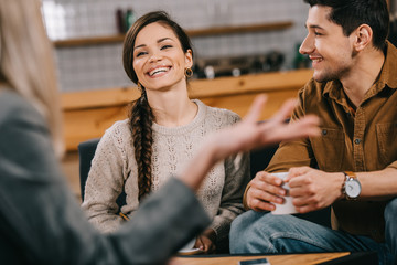 selective focus of cheerful friends chatting in cafe