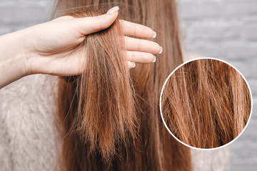 Texture of damaged female hair close-up on gray background. concept loss color and protein