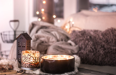 home still life in the interior with beautiful candles, on the background of a cozy home decor