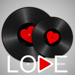 Two Realistic Black Vinyl Records with red heart labels, lettering In love mode and play button. Retro concept of music and romance - 243281924