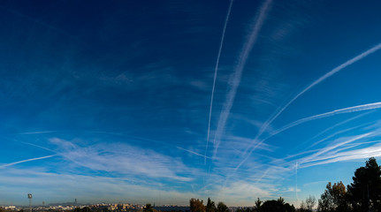 Airplane chemtrails in blue sky