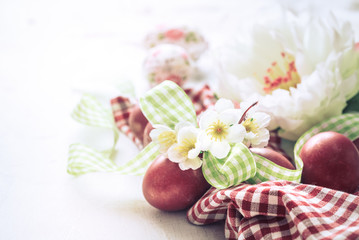 Easter background with a basket and red eggs with flowers