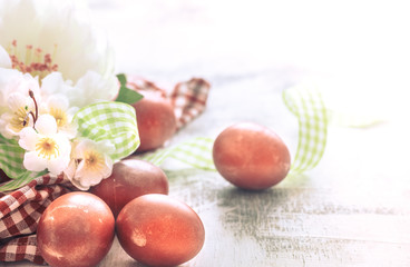 Easter background with a basket and red eggs with flowers