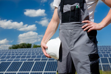 Solar panels engineer or worker holding white protective cask
