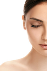 The beautiful female face. The perfect and clean skin of face on white. half face with eyes closed