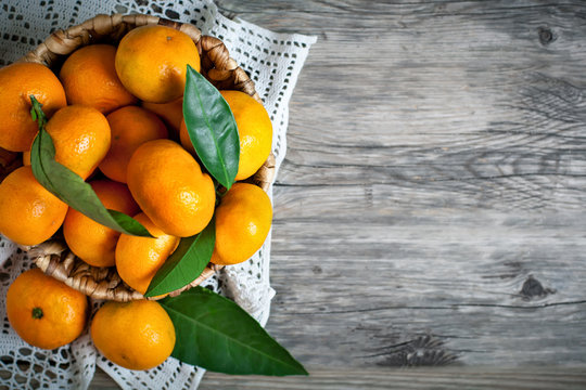 Fresh ripe mandarin oranges (clementine, tangerine) with green leaves on  retail market display, close up, high angle view Stock Photo - Alamy