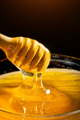 Honey with gold color flows down from a spoon. Healthy food concept. Healthy eating. Diet. Selective focus.