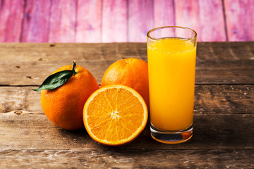 Orange juice and fresh oranges