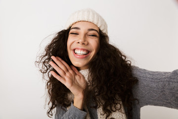 Cheerful young woman wearing winter scarf standing